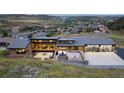 Stunning modern home with a large patio and mountain views, perfect for entertaining and enjoying the outdoors at 17401 Snowcreek Ln, Morrison, CO 80465