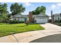 Inviting home with well-kept lawn, a two-car garage, complemented by mature trees and established landscaping at 5193 S Flanders Ln, Centennial, CO 80015