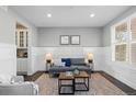 Comfortable living room featuring stylish decor, wainscoting, and a large window at 27596 E Jamison Cir, Aurora, CO 80016