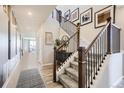 Inviting entryway with a staircase featuring wood and black iron railings at 1350 Loraine N Cir, Lafayette, CO 80026