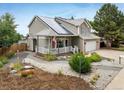 Inviting two-story home with solar panels, a welcoming porch, and beautiful, low-maintenance landscaping at 2777 W 106Th Cir, Denver, CO 80234