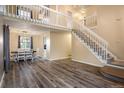 Open-concept living space with high ceilings, hardwood floors, and staircase to the second level at 2777 W 106Th Cir, Denver, CO 80234