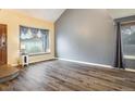Bright living room featuring hardwood floors, neutral paint, a large bay window, and ample natural light at 2777 W 106Th Cir, Denver, CO 80234