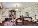 Formal dining room featuring decorative wallpaper, vintage furniture and ample seating at 3825 S Peach Way, Denver, CO 80237