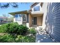 Inviting front entrance with well-maintained landscaping and a charming front door at 11191 W Crestline Dr, Littleton, CO 80127