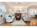 Bright living room featuring a decorative fireplace, hardwood floors, and an archway to other rooms at 569 S Race St, Denver, CO 80209