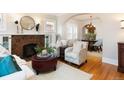 Open living room with fireplace, hardwood floors, and an archway leading to the dining room at 569 S Race St, Denver, CO 80209