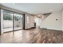 Open living area with hardwood floors and sliding glass doors to deck and backyard at 9605 E Kansas Cir # 53, Denver, CO 80247
