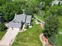 A stunning aerial view of the home showcasing its well-maintained lawn, mature trees, and inviting curb appeal at 7999 Centrebridge Dr, Niwot, CO 80503