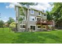 Spacious backyard featuring a deck, lush lawn, and mature trees, perfect for outdoor entertaining at 7999 Centrebridge Dr, Niwot, CO 80503