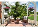 Cozy porch with comfortable seating, decorative flowers, and a serene view of the landscaped front yard at 7999 Centrebridge Dr, Niwot, CO 80503