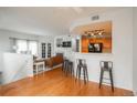 Bright living room with hardwood floors flowing into an open-concept kitchen at 8707 E Florida Ave # 510, Denver, CO 80247