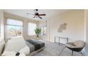 Bright bedroom features a ceiling fan, ample natural light, and a cozy seating area at 2500 E Cherry Creek South Dr # 213, Denver, CO 80209