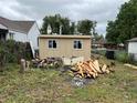 Backyard with construction debris and a small outbuilding with two windows at 1037 Hazel Ct, Denver, CO 80204