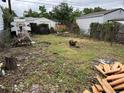 Backyard strewn with debris, fenced perimeter, and signs of neglected landscaping at 1037 Hazel Ct, Denver, CO 80204