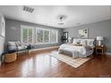 Spacious main bedroom with large windows, hardwood floors, and ample natural light at 1366 S Vine St, Denver, CO 80210