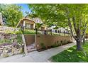 Beautiful home exterior with a well-maintained lawn and stylish retaining wall at 1366 S Vine St, Denver, CO 80210