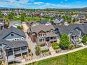Gorgeous aerial view of a two-story home with lush green yard and scenic neighborhood in the background at 4378 Fell Mist Way, Castle Rock, CO 80109