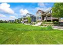 View of multiple homes along a community streetscape with lush green spaces and manicured front yards at 4378 Fell Mist Way, Castle Rock, CO 80109