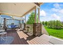 Inviting covered porch featuring a comfortable swing, tasteful decor, and outdoor living space at 4378 Fell Mist Way, Castle Rock, CO 80109