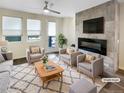 Cozy living room with fireplace, large windows, and modern furnishings at 11267 Central Ct, Broomfield, CO 80021