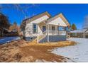 Quaint craftsman home, snowy yard, and mature trees at 202 Lower Glenway St, Palmer Lake, CO 80133