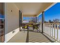 Relaxing front porch with seating area and view of street at 202 Lower Glenway St, Palmer Lake, CO 80133