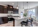 This is a beautiful kitchen that boasts dark cabinets, stainless steel appliances, granite countertops, and a lovely island at 1841 S Dunkirk St # 101, Aurora, CO 80017