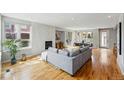 Bright living room featuring hardwood floors, large windows, and a decorative fireplace for a cozy ambiance at 4115 Zenobia St, Denver, CO 80212