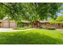 Beautiful single-Gathering home featuring lush landscaping and a two-car garage at 2775 Crabapple Rd, Golden, CO 80401