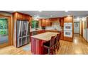 Spacious kitchen with wood cabinetry, stainless steel appliances, and center island at 2775 Crabapple Rd, Golden, CO 80401