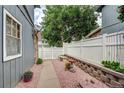 Backyard featuring a decorative rock garden area with a white privacy fence at 2829 S Xanadu Way, Aurora, CO 80014