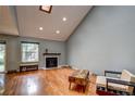 Spacious living room with wood floors, vaulted ceiling, a window, and natural light at 2829 S Xanadu Way, Aurora, CO 80014