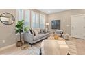 Bright living room with large windows, modern furniture, and stylish decor at 239 W Jamison Ct, Littleton, CO 80120
