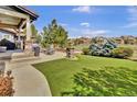 Expansive backyard with lush green grass and an outdoor patio ideal for entertaining or relaxation at 10492 Willowwisp Way, Highlands Ranch, CO 80126