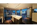Contemporary kitchen with stainless island, modern appliances, and expansive windows overlooking the city at 55 W 12Th Ave # 512, Denver, CO 80204