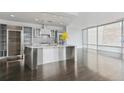 Bright open kitchen with stainless island, floor-to-ceiling windows, and modern appliances at 55 W 12Th Ave # 512, Denver, CO 80204