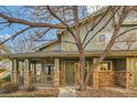 Charming two story home with a covered front porch featuring brick accents and mature landscaping at 2900 Purcell St # I4, Brighton, CO 80601