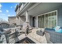 Relaxing porch with comfortable seating, a small table, and a clear view of the front entrance at 7484 W Atlantic Ln, Denver, CO 80227