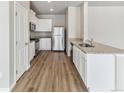 Modern kitchen featuring white cabinets, stainless steel appliances, and granite countertops at 869 Sawdust Dr, Brighton, CO 80601