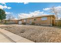 A charming ranch style house with a brick exterior and steps leading to the front door at 6581 S Logan St, Centennial, CO 80121