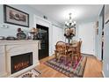 Cozy dining area featuring a fireplace, wooden table with chairs, and a decorative rug at 3550 S Harlan St # 174, Denver, CO 80235