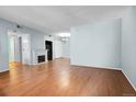Bright living room featuring hardwood floors and an electric fireplace for a cozy ambiance at 3550 S Harlan St # 174, Denver, CO 80235