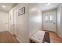 Bright entryway featuring hardwood floors, a stylish front door, and a cozy bench at 7160 Canosa Ct, Westminster, CO 80030