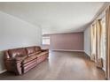 Bright living room featuring hardwood floors, neutral paint, and large windows at 3625 E 128Th Pl, Thornton, CO 80241