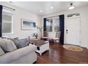 Cozy living room featuring hardwood floors, neutral walls, natural light, and stylish furniture at 9084 Ellis Way, Arvada, CO 80005