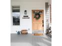 Charming front porch featuring a wooden door adorned with a wreath and decorative welcome accents at 5962 S Sheridan Way, Littleton, CO 80123
