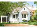 Charming home with light blue siding, manicured landscaping, and a covered front porch at 539 Baker St, Longmont, CO 80501