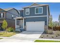 Charming two-story home with a well-maintained lawn and a two-car garage on a sunny day at 1107 Sunrise Dr, Brighton, CO 80603