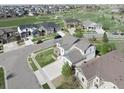 Aerial view of a two-story home in a neighborhood setting with easy access to a large park at 404 Dusk Ct, Erie, CO 80516